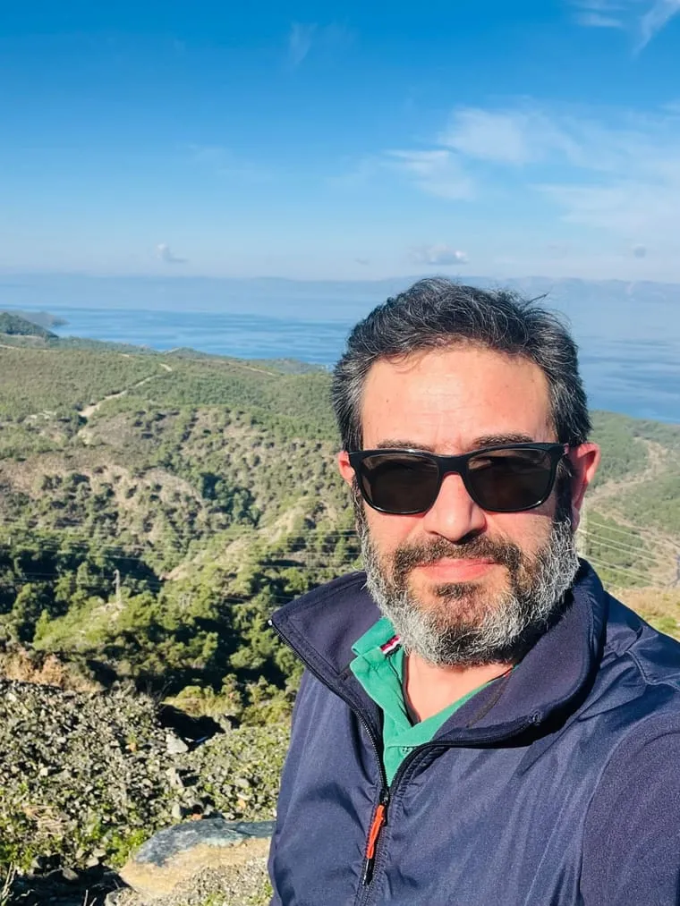 Dentist Can Sağlat on a nature walk on wooded hills overlooking the sea